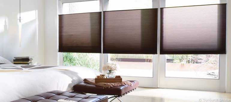 Modern Indianapolis bedroom with tall windows and vertical honeycomb shades.