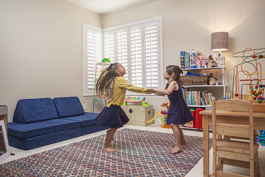 Choose Polywood shutters for durable, kid-friendly great room window treatments in Indianapolis. Polywood shutters on multiple windows in a sitting area
