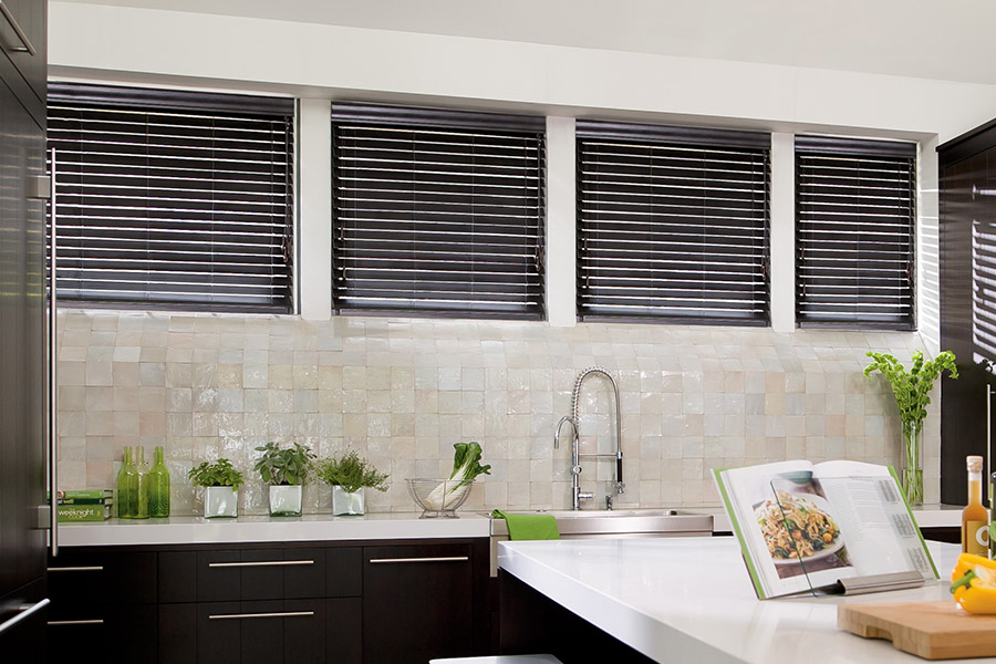 Choose custom Polywood faux wood blinds for your kitchen in Indianapolis. Special shaped faux wood blinds in several windows above a sink.