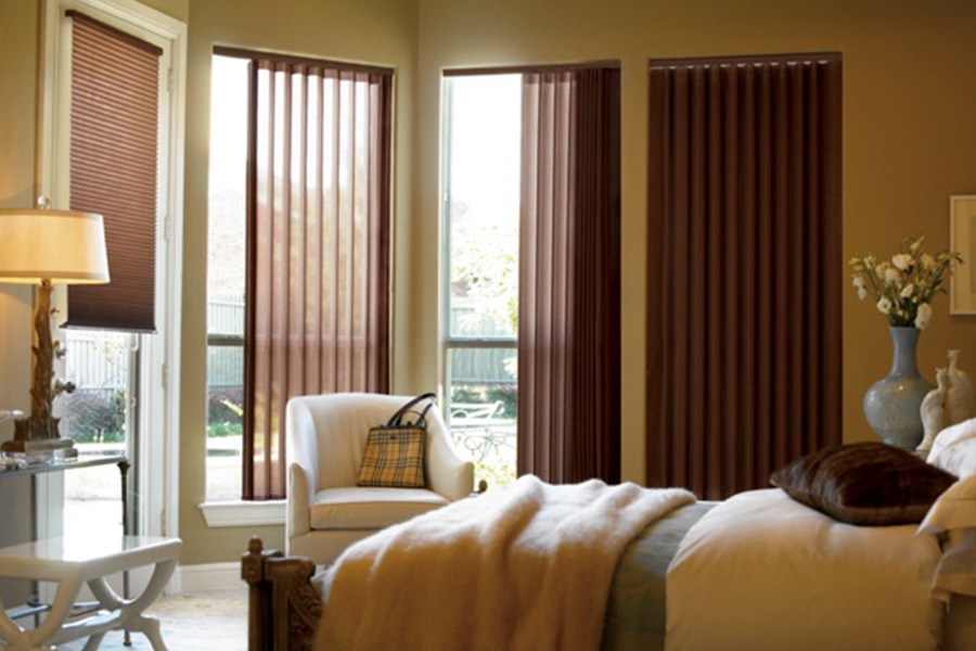 Choose durable and high-quality fabric or vinyl vertical blinds in Indianapolis. Maroon fabric vertical blinds inside a bedroom