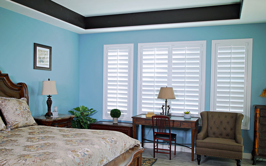 Polywood shutters provide insulation for the perfect temperature all year long in Indianapolis. Polywood shutters in a bedroom.