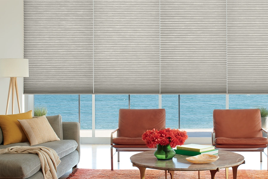 Make your life easier with motorized window shades when covering large windows like these. Stylish gray window shades in a living room
