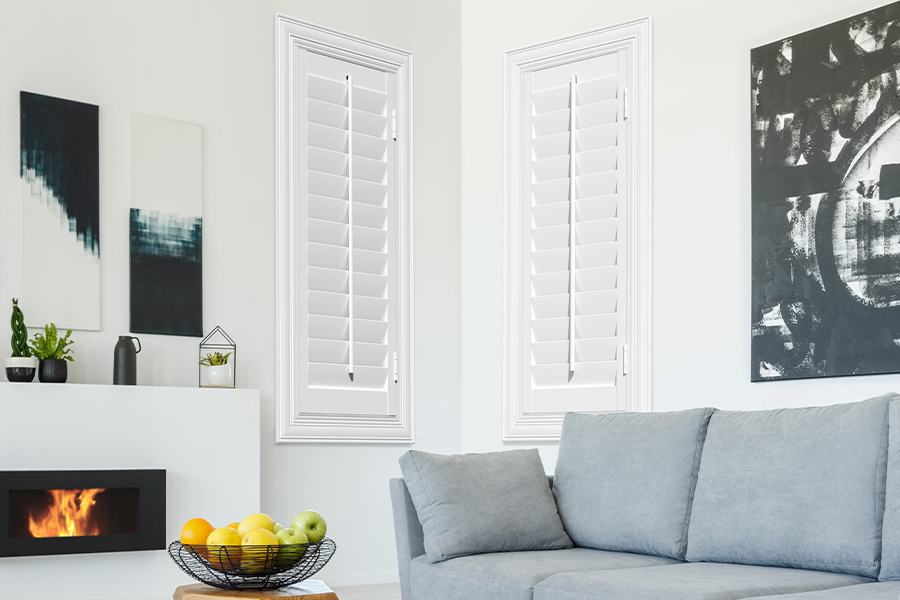 White Polywood shutters add character and class in Indianapolis. White polywood shutters in a corner of a modern living room.