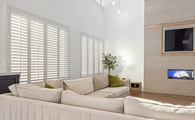 white shutters in a large beige living room area