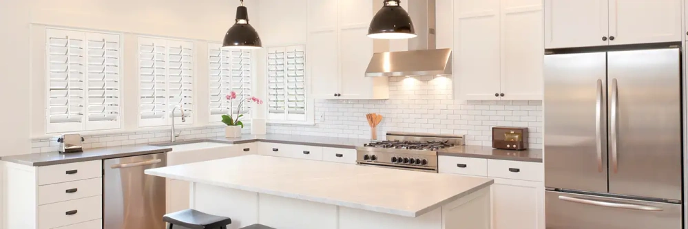 White Polywood shutters on windows in a white modern kitchen